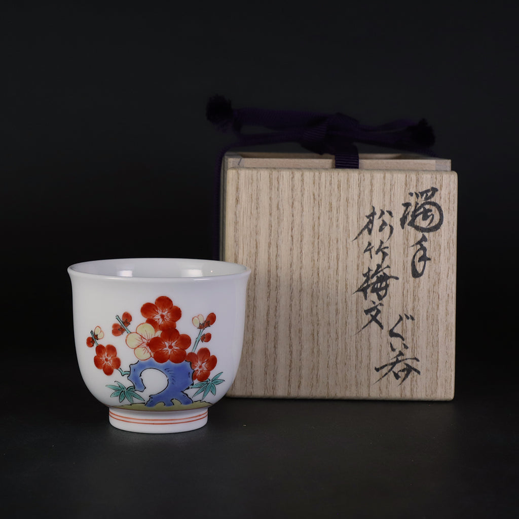 A sake cup with a pine, bamboo and plum motif made by the A sake cup with a pine, bamboo and plum motif made by the