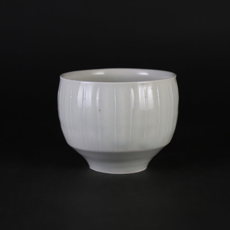 Small white porcelain teacup with ridged edge made by Shingo Oka