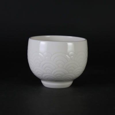 White porcelain sake cup with blue sea wave pattern by Manji Inoue