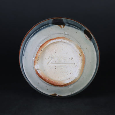 Red-painted spinning top design bottle by Shingo Oka