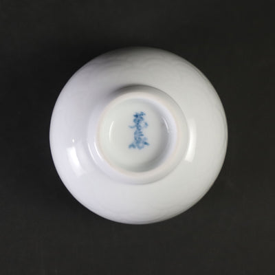 White porcelain sake cup with blue ocean wave pattern by Manji Inoue