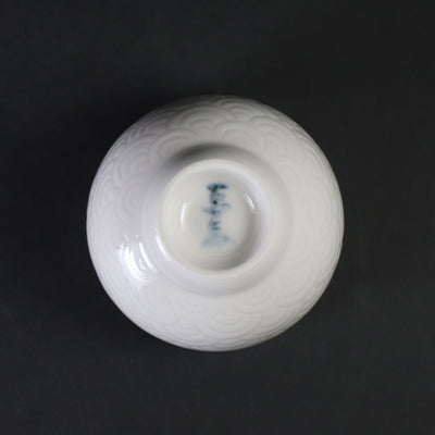 White porcelain sake cup with blue sea wave pattern by Manji Inoue