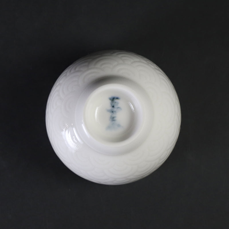 White porcelain sake cup with blue sea wave pattern by Manji Inoue