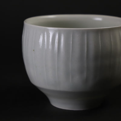 Small white porcelain teacup with ridged edge made by Shingo Oka