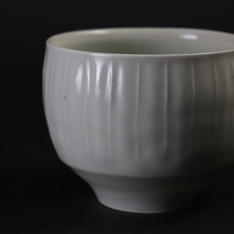 Small white porcelain teacup with ridged edge made by Shingo Oka