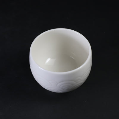 White porcelain sake cup with blue sea wave pattern by Manji Inoue
