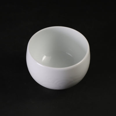 White porcelain sake cup with blue ocean wave pattern by Manji Inoue