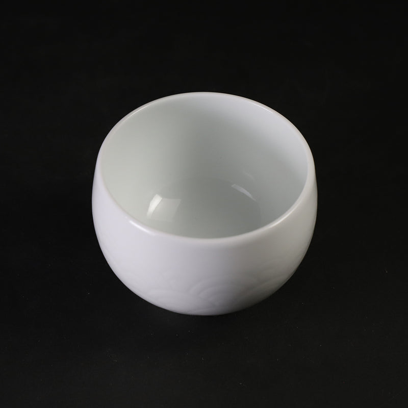 White porcelain sake cup with blue ocean wave pattern by Manji Inoue