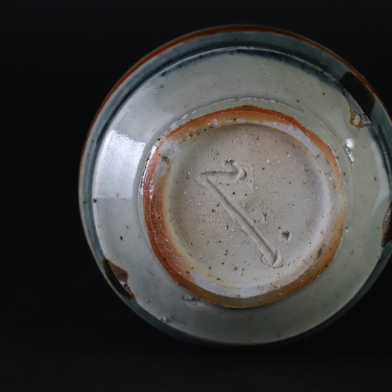 Red-painted spinning top design bottle by Shingo Oka
