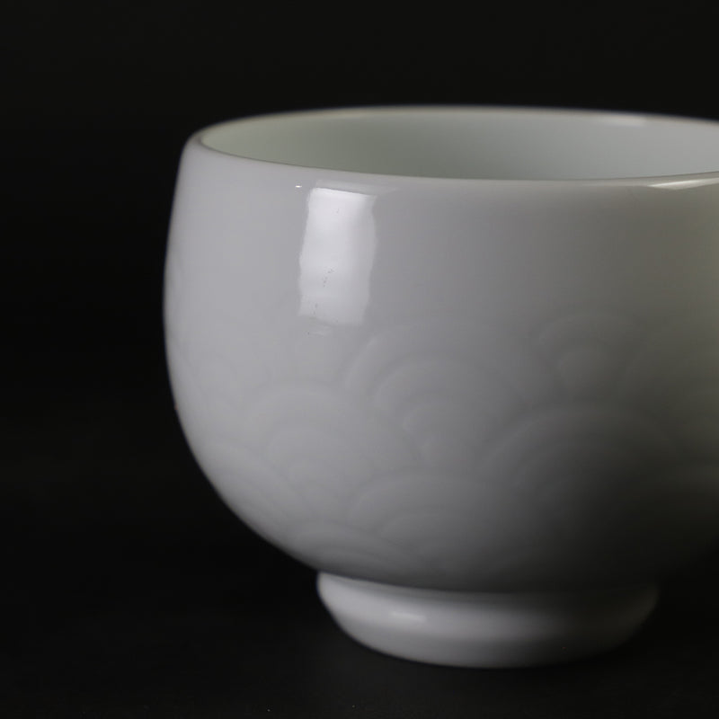 White porcelain sake cup with blue ocean wave pattern by Manji Inoue