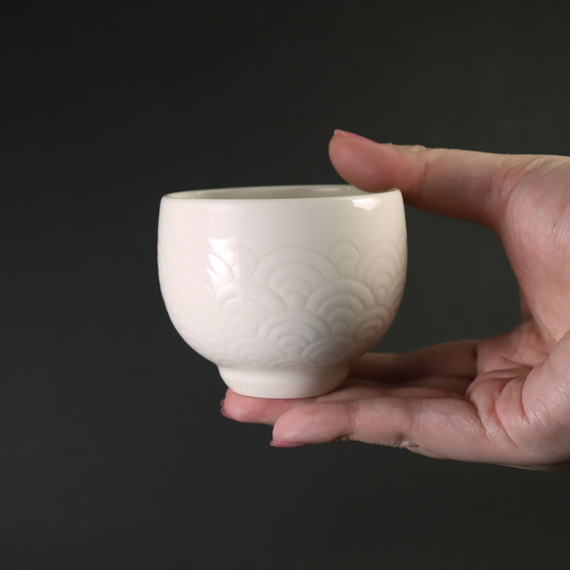 White porcelain sake cup with blue sea wave pattern by Manji Inoue
