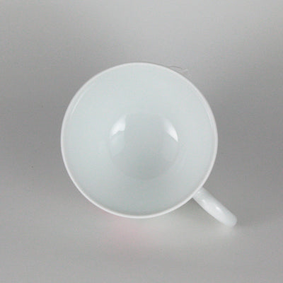 Manji Inoue white porcelain coffee bowl with green glaze and cherry blossom engraving