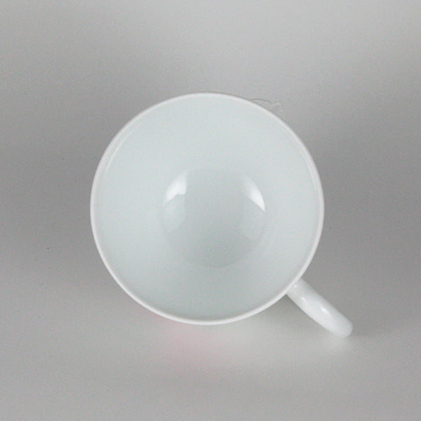 Manji Inoue white porcelain coffee bowl with green glaze and cherry blossom engraving