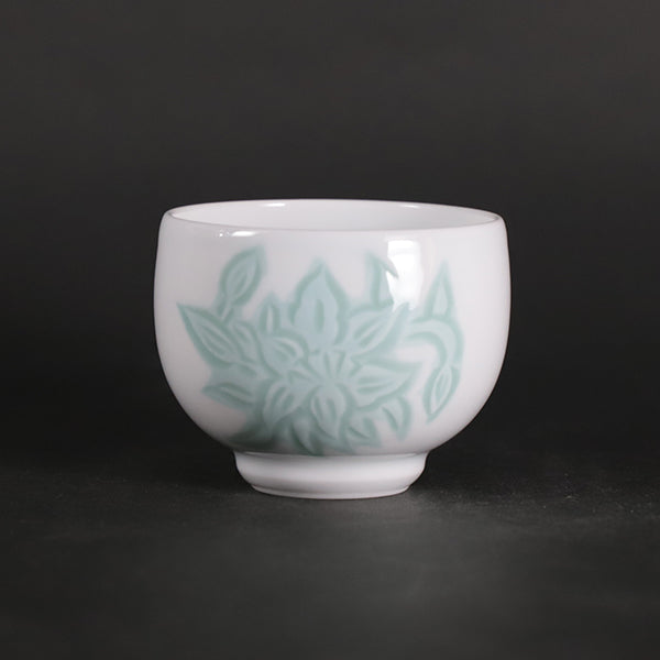 Manji Inoue white porcelain green glaze lily design sake cup